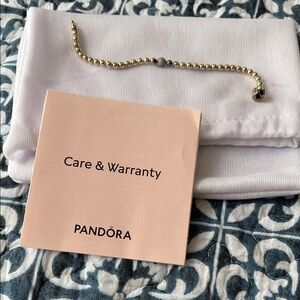 Pandora Silver beaded bracelet with crystal in the center.